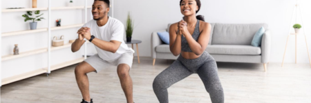 fit-woman-and-her-boyfriend-doing-squats-together-at-home-to-take-care-of-their-digestive-health